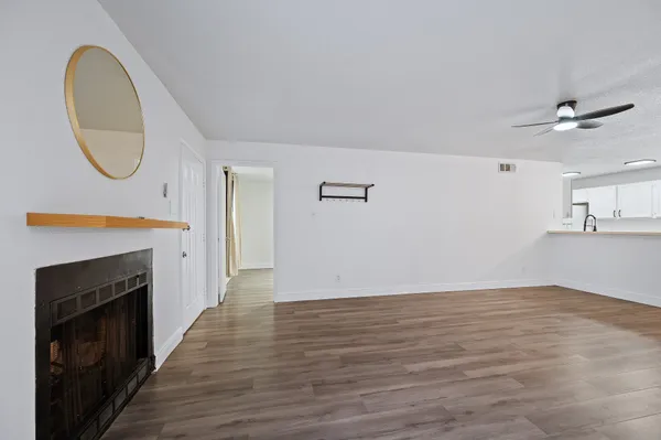 a view of a hallway with wooden floor and staircase