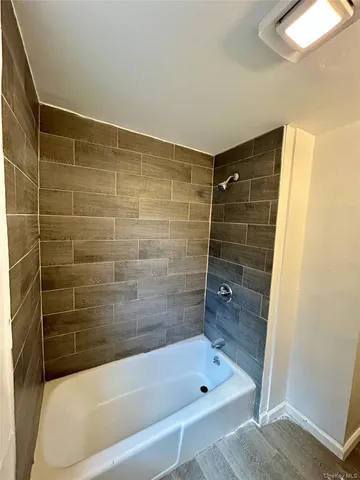 a bathroom with a shower and bathtub