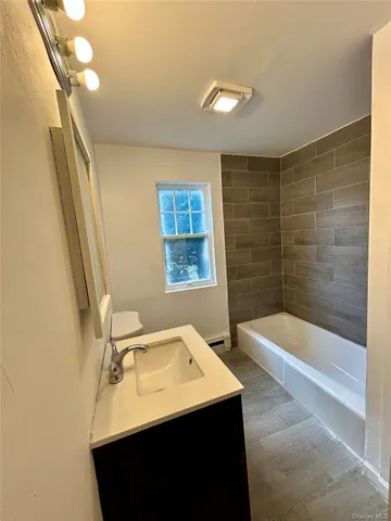 a bathroom with a sink a bathtub and a shower