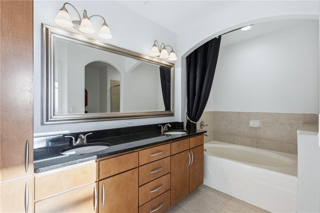 3445 Stratford Road Northeast, Unit 3601 Atlanta, GA 30326 - Photo 13 of 37 a bathroom with a sink and a mirror