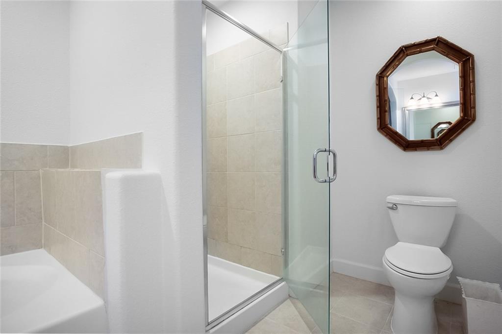 3445 Stratford Road Northeast, Unit 3601 Atlanta, GA 30326 - Photo 14 of 37 a bathroom with a toilet and a mirror