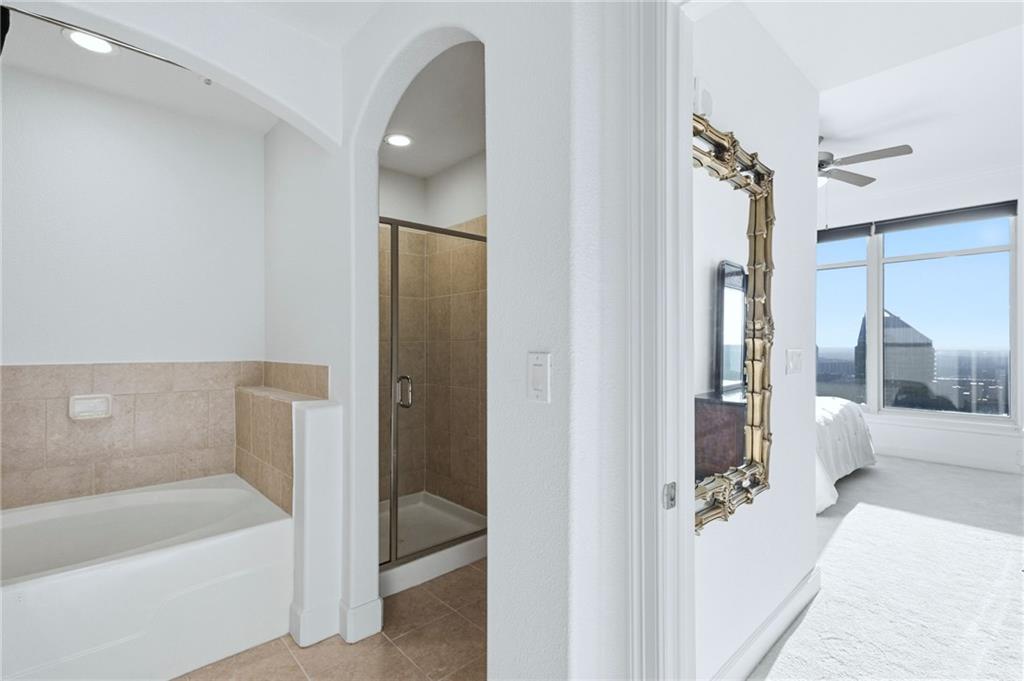 3445 Stratford Road Northeast, Unit 3601 Atlanta, GA 30326 - Photo 15 of 37 a bathroom with a tub shower and sink