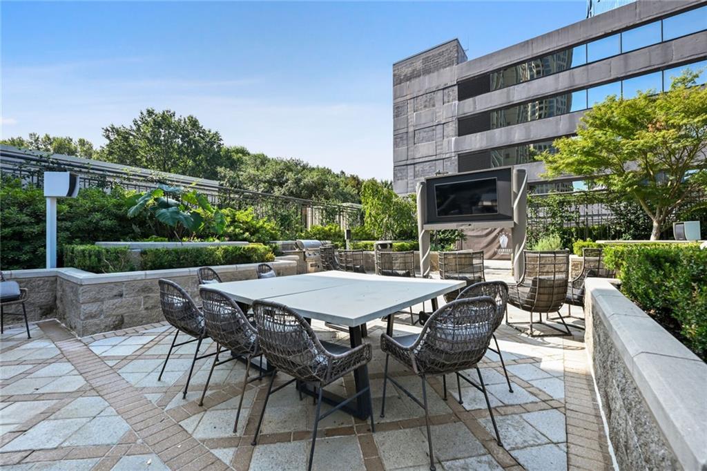 3445 Stratford Road Northeast, Unit 3601 Atlanta, GA 30326 - Photo 30 of 37 a view of a patio with a table and chairs