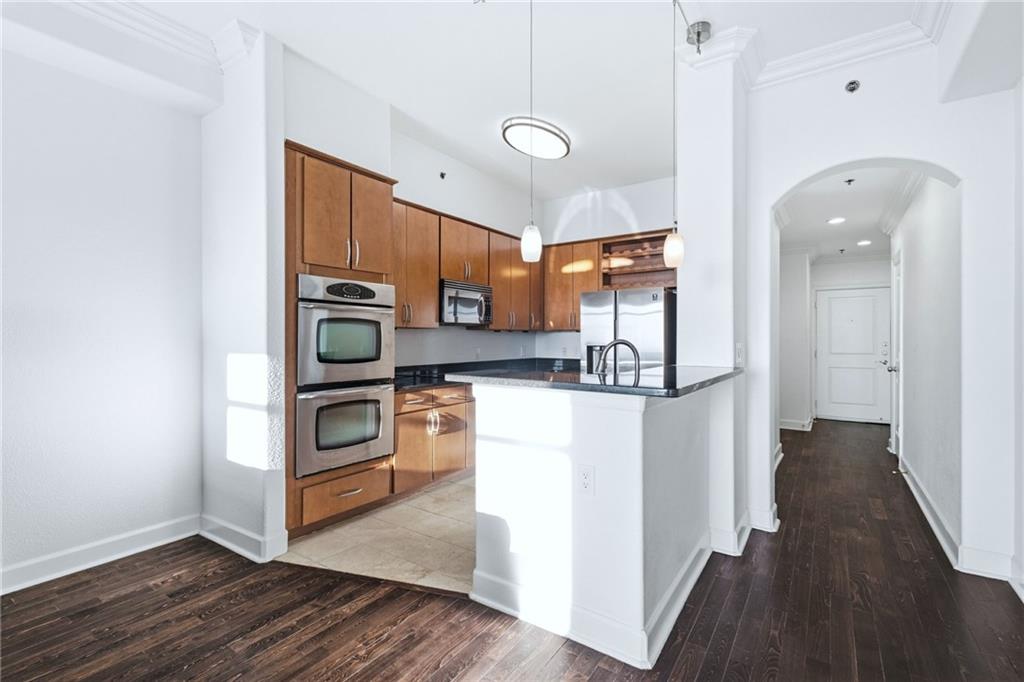 3445 Stratford Road Northeast, Unit 3601 Atlanta, GA 30326 - Photo 5 of 37 a view of a kitchen with wooden floor and electronic appliances