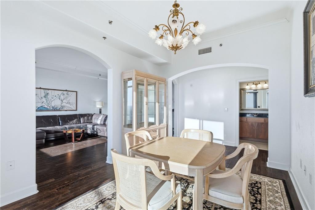 3445 Stratford Road Northeast, Unit 3601 Atlanta, GA 30326 - Photo 7 of 37 a view of a dining room with furniture a chandelier and wooden floor