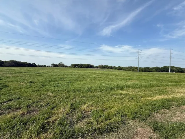 a view of a field with an ocean