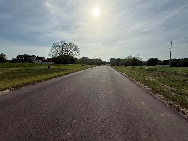a view of a golf course with a road