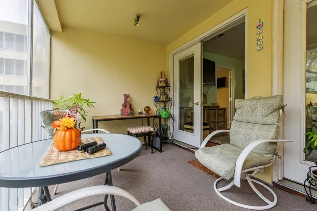 a bedroom with a bed couch and window
