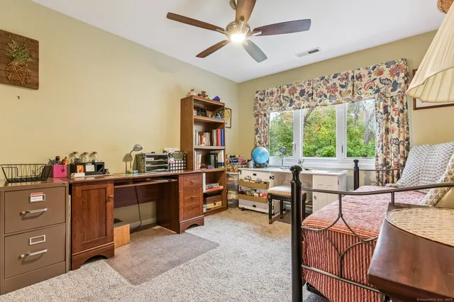 a spacious bedroom with a bed and furniture