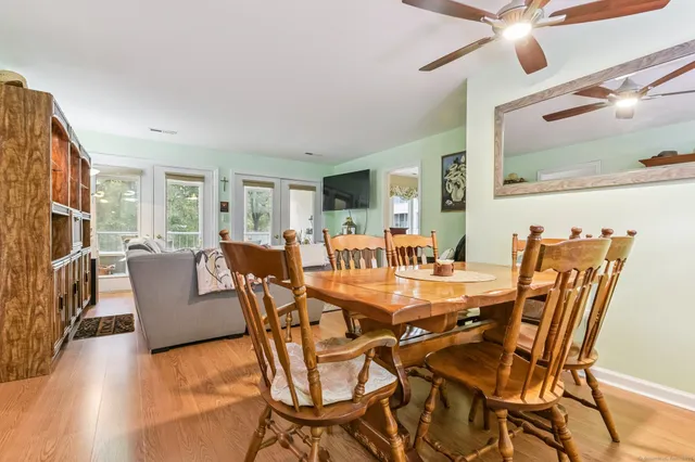 a view of a dining room with furniture and a ceiling fan
