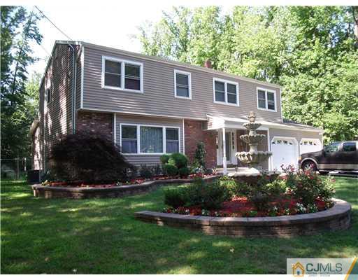 4 Regal Road Edison, NJ 08820 - Photo 1 of 10 a front view of a house with a yard and potted plants