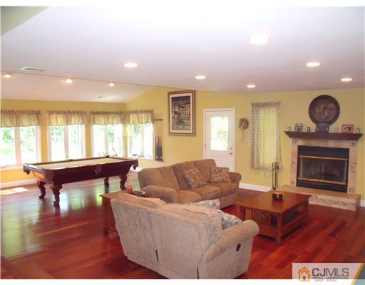 4 Regal Road Edison, NJ 08820 - Photo 2 of 10 a living room with furniture a fireplace and a large window