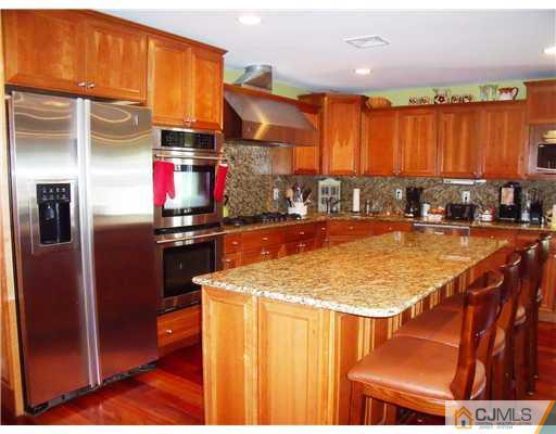 4 Regal Road Edison, NJ 08820 - Photo 3 of 10 a kitchen with stainless steel appliances granite countertop a sink and cabinets