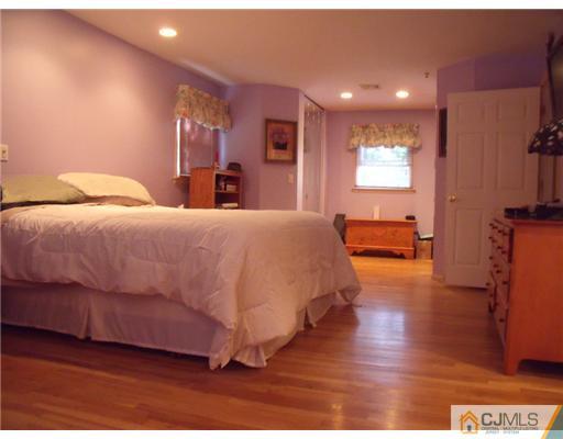 4 Regal Road Edison, NJ 08820 - Photo 7 of 10 a bedroom with a bed and a view of kitchen