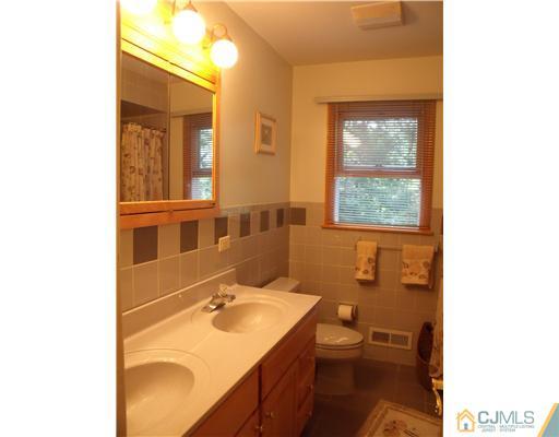 4 Regal Road Edison, NJ 08820 - Photo 9 of 10 a bathroom with a sink and a mirror