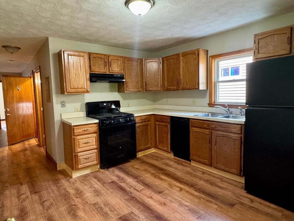 68 Maverick Street Chelsea, MA 02150 - Photo 3 of 16 a kitchen with a sink stove and refrigerator