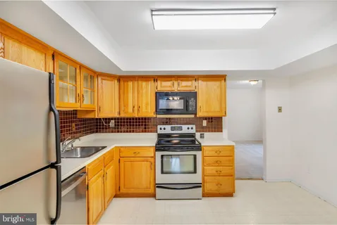 a kitchen with stainless steel appliances granite countertop a stove and a refrigerator