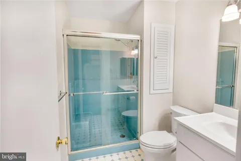 a bathroom with a shower a toilet and a sink