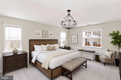 a bedroom with bed and window with chair