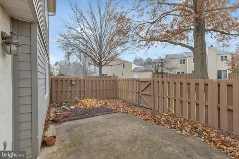 a view of a yard with wooden fence