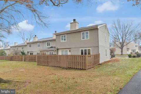 a view of a house with wooden fence