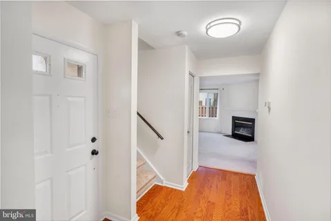 a view of a livingroom with wooden floor and staircase