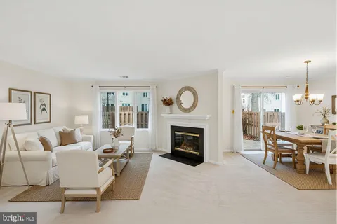 a living room with furniture a fireplace and a window