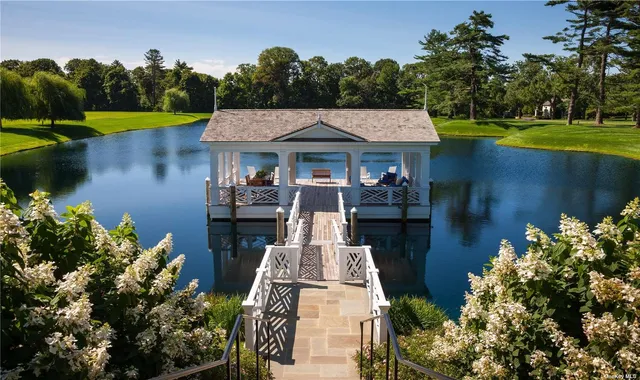 a view of a house with pool and a yard