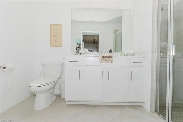 a bathroom with a sink a toilet and mirror