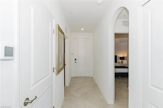 a view of a hallway with wooden floor and entryway