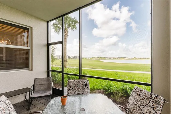 a living room filled with furniture and a large window