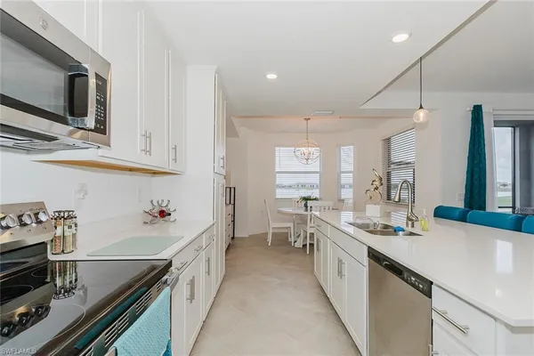 a kitchen with stainless steel appliances a sink stove and cabinets