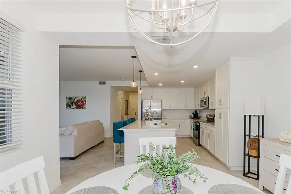 a living room with furniture and kitchen view