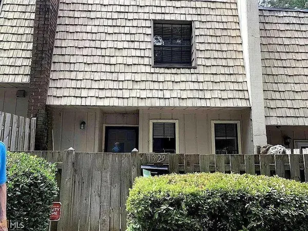 a view of a house with brick walls and potted plants