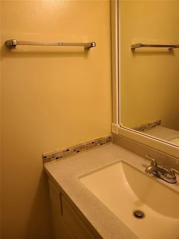 a bathroom with a shower and a sink