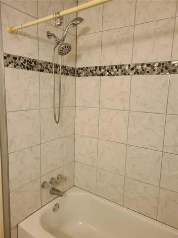 a bathroom with a shower and a sink
