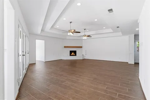 a view of a livingroom with a fireplace and chandelier