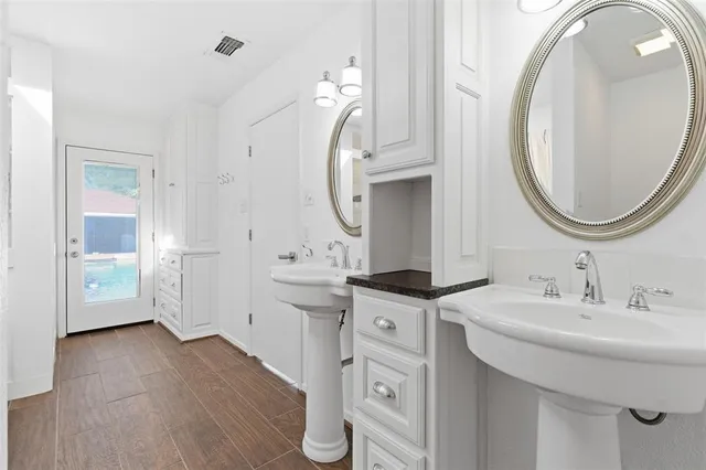 a spacious bathroom with a sink a mirror and a mirror