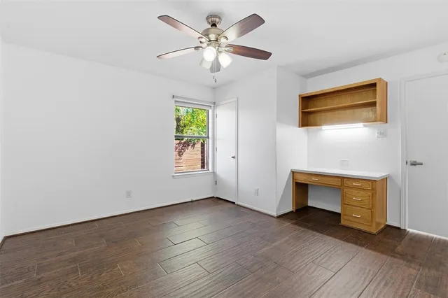 an empty room with windows and a fireplace