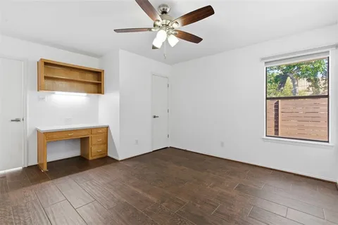 a view of an empty room with a window and a fireplace