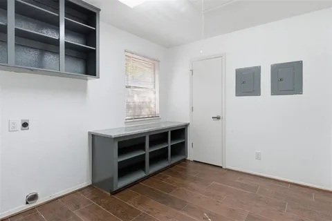 a view of an empty room with a cabinet and a window
