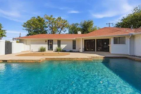 a house with swimming pool in front of it
