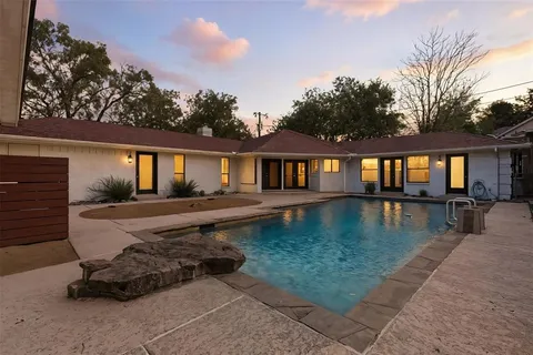 a swimming pool with outdoor seating