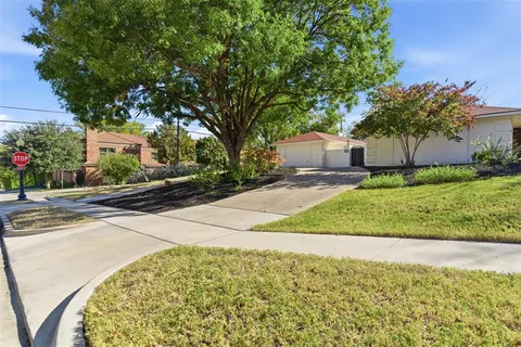 a front view of a house with a yard and a garage