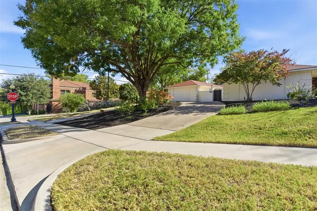 a front view of a house with a yard and a garage