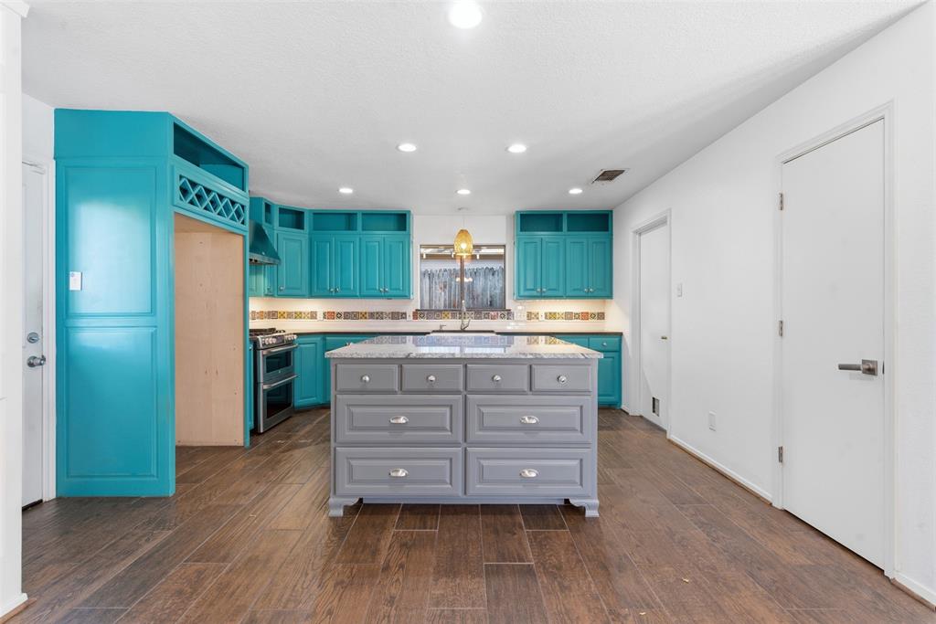 2201 Mistletoe Boulevard Fort Worth, TX 76110 - Photo 5 of 31 a kitchen with granite countertop a sink cabinets and wooden floor