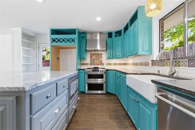 a kitchen with kitchen island granite countertop a sink counter top space stainless steel appliances and cabinets