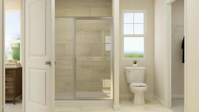 a bathroom with a toilet and a shower