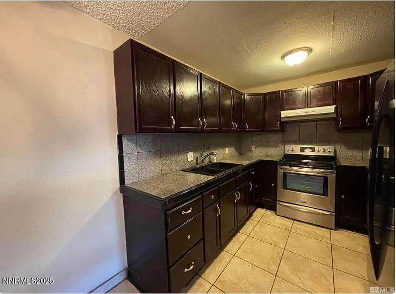 2375 Tripp Drive, Unit 9 Reno, NV 89512 - Photo 2 of 10 a kitchen with granite countertop stainless steel appliances and wooden cabinets