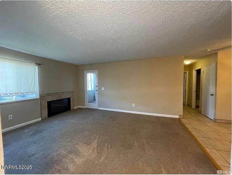 2375 Tripp Drive, Unit 9 Reno, NV 89512 - Photo 3 of 10 a view of an empty room with a fireplace